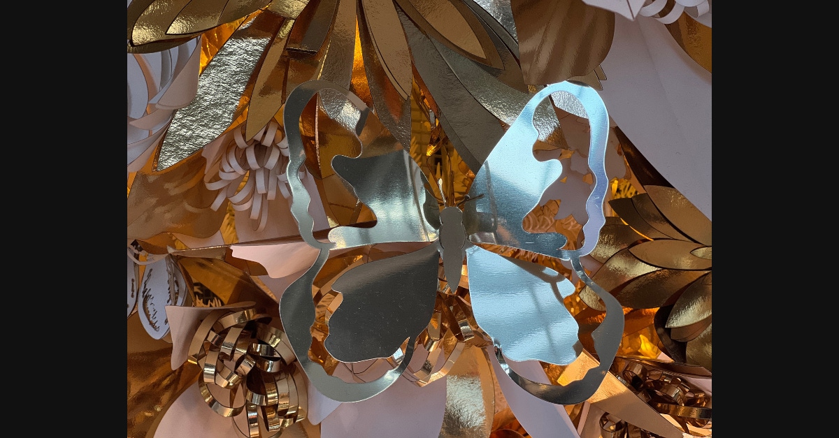 A gold butterfly on Dior's Christmas display made by precise laser cutting expertise